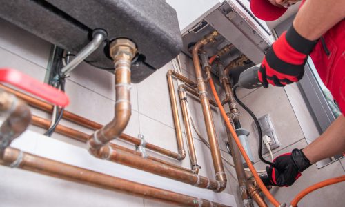 Heating Specialist with Gas Leak Detector in His Hand Heating Specialist with Gas Leak Detector in His Hand Performing Necessary Check